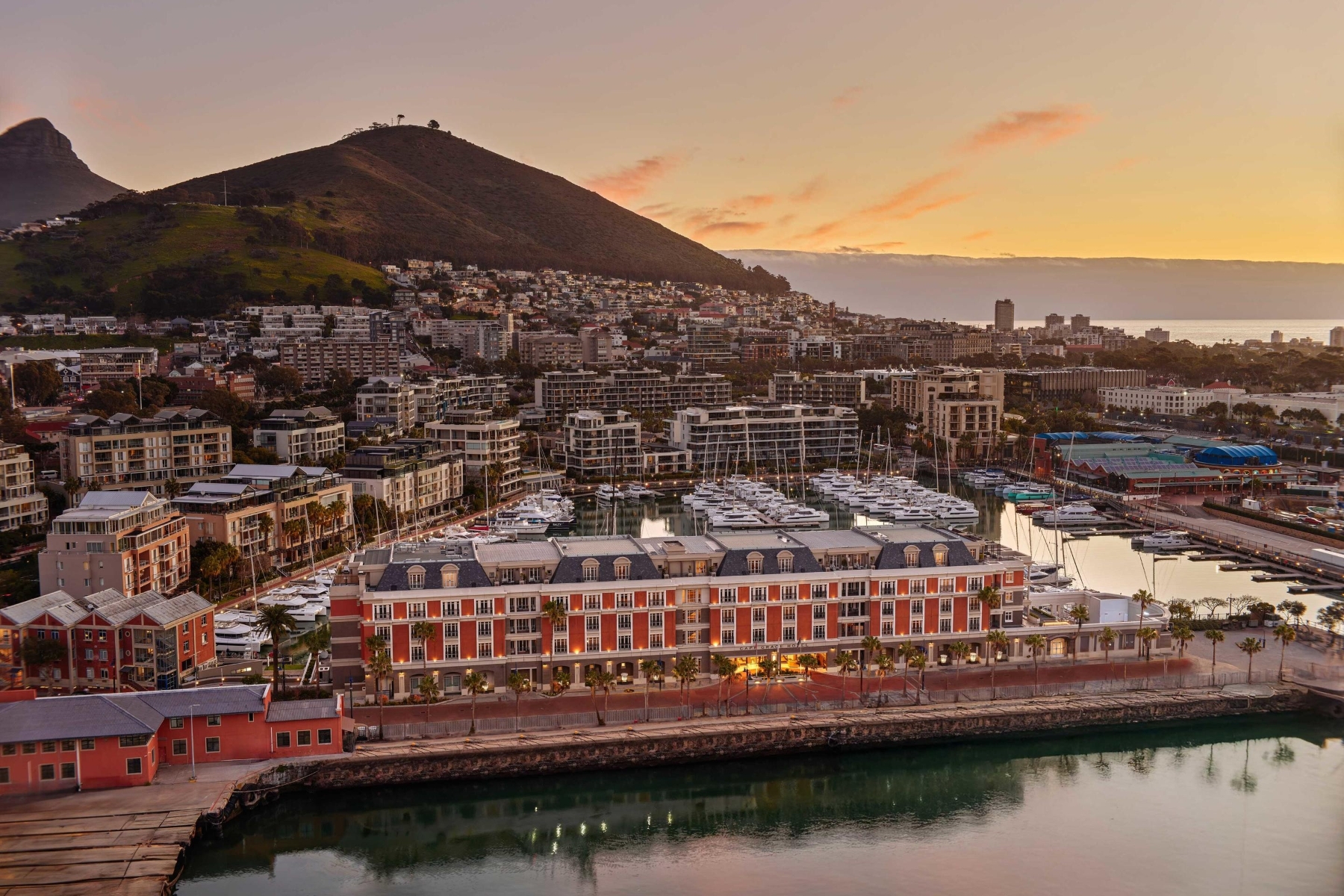 Cape-Grace-exterior An aerial view of Cape Grace, one of the luxury hotels in Cape Town, framed by a marina and the city’s rising hills