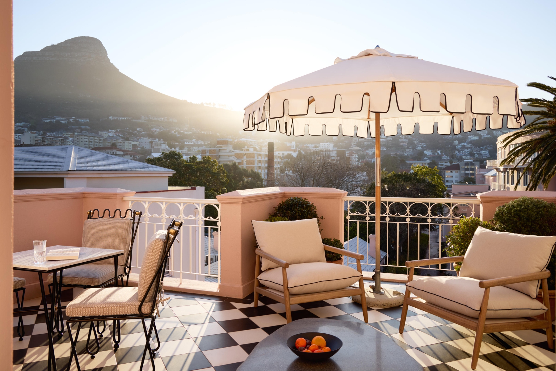 Mount-nelson-presidential-suite A sunlit terrace with cushioned chairs and mountain views at one of the luxury hotels in Cape Town