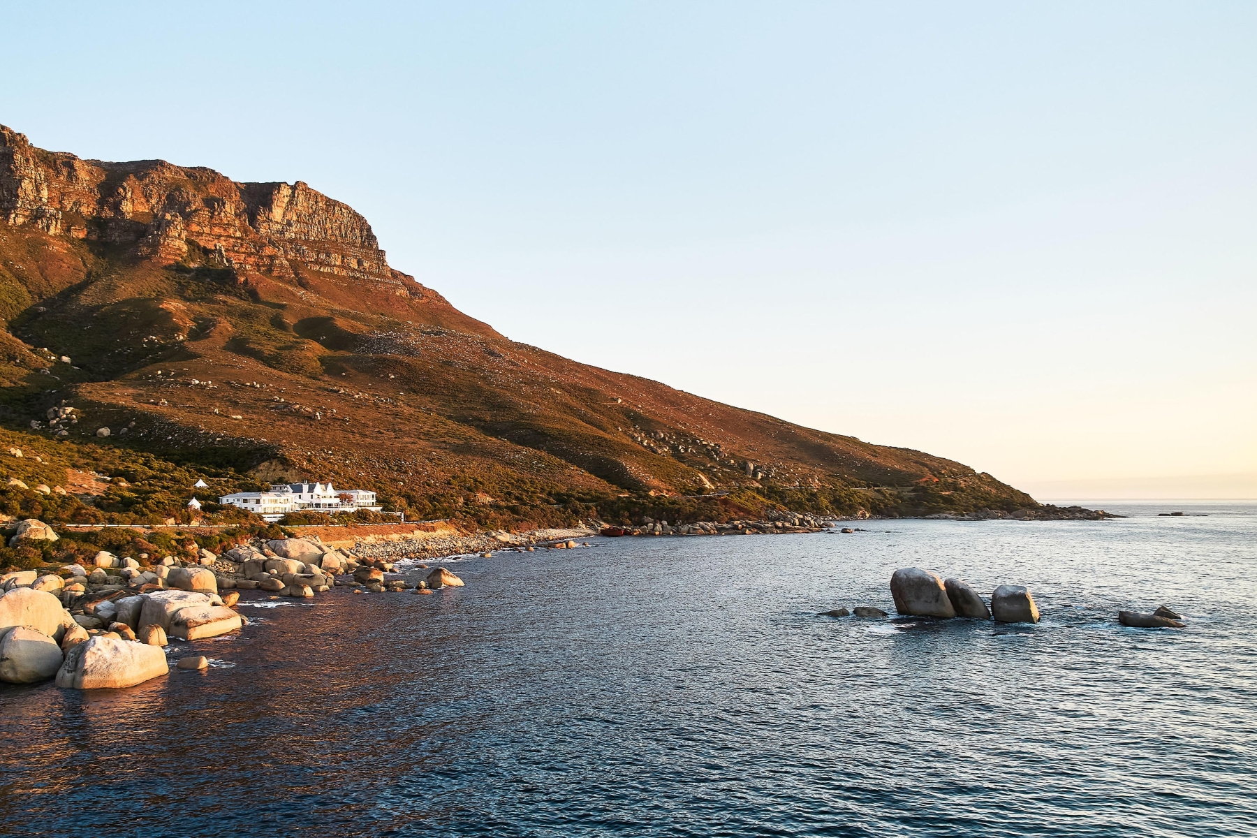 Twelve-Apostles-exterior A coastal hotel set against a rugged mountainside, perfectly isolated among the luxury hotels in Cape Town
